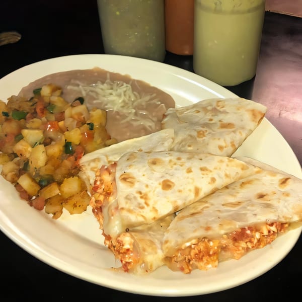 Dona Mary's Mexican quesadillas with refried beans and diced potatoes, served with various salsas.